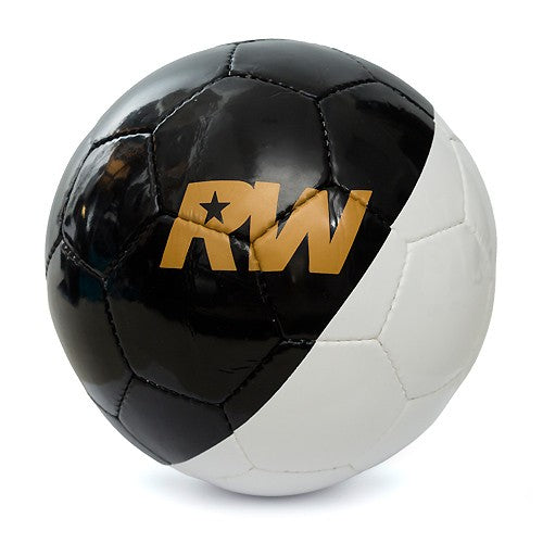 A black and white soccer ball with a prominent gold 'RW' logo printed on the black panel, set against a clean white background.